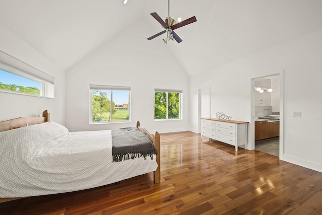 3810 Bellefontaine St, Houston, TX 77025 - bedroom with wood-type flooring, high vaulted ceiling, baseboards, connected bathroom, and ceiling fan