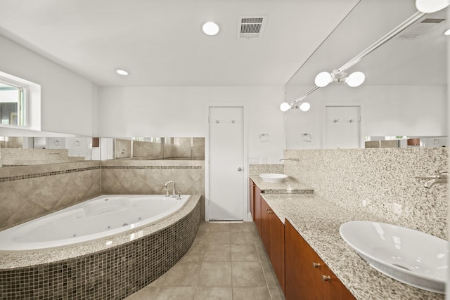 3810 Bellefontaine St, Houston, TX 77025 - full bath with a tub with jets, double vanity, and tile patterned floors