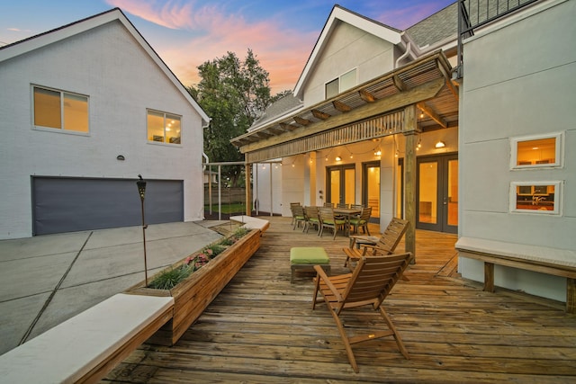 3810 Bellefontaine St, Houston, TX 77025 - deck at dusk featuring french doors, outdoor dining space, and a garage