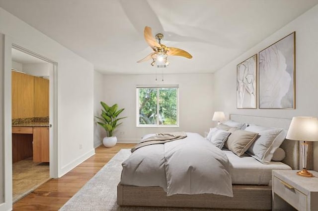 3810 Bellefontaine St, Houston, TX 77025 - bedroom with wood finished floors, ensuite bath, and a ceiling fan