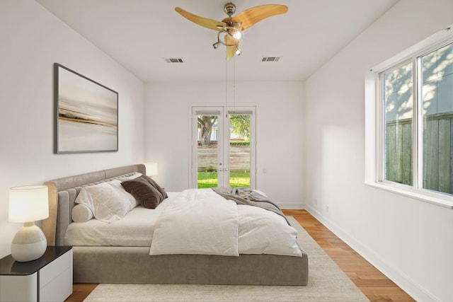 3810 Bellefontaine St, Houston, TX 77025 - bedroom featuring multiple windows, access to outside, light wood-type flooring, and ceiling fan