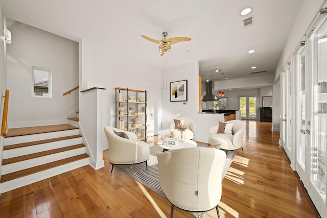 3810 Bellefontaine St, Houston, TX 77025 - living room featuring hardwood / wood-style floors, stairs, and recessed lighting