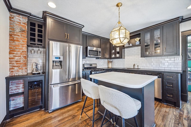 2229 Singleton St, Houston, TX 77008 - kitchen with appliances with stainless steel finishes, dark wood-style flooring, a sink, decorative backsplash, and glass insert cabinets