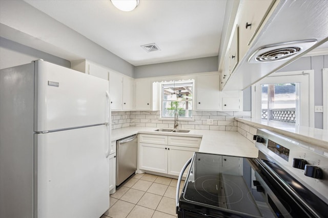 5227 Willowbend Blvd, Houston, TX 77096 - kitchen with stainless steel appliances, a sink, tasteful backsplash, light countertops, and white cabinets