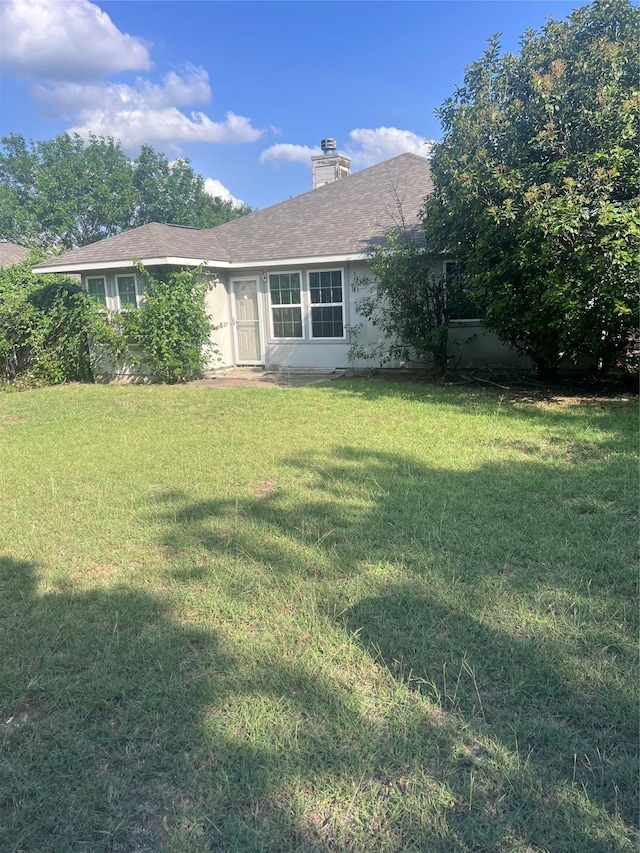 7340 Muffin Dr, Austin, TX 78724 - view of front of property with a front lawn and a chimney