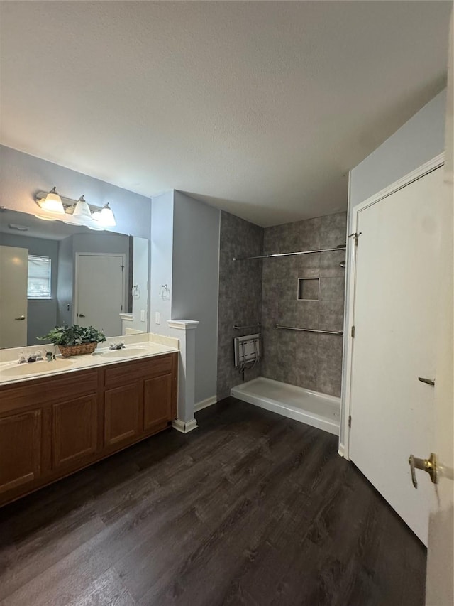 7340 Muffin Dr, Austin, TX 78724 - full bathroom with wood finished floors, double vanity, shower / tub combination, and baseboards
