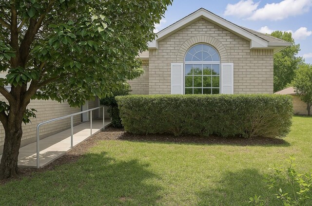 7340 Muffin Dr, Austin, TX 78724 - view of side of property with brick siding and a yard