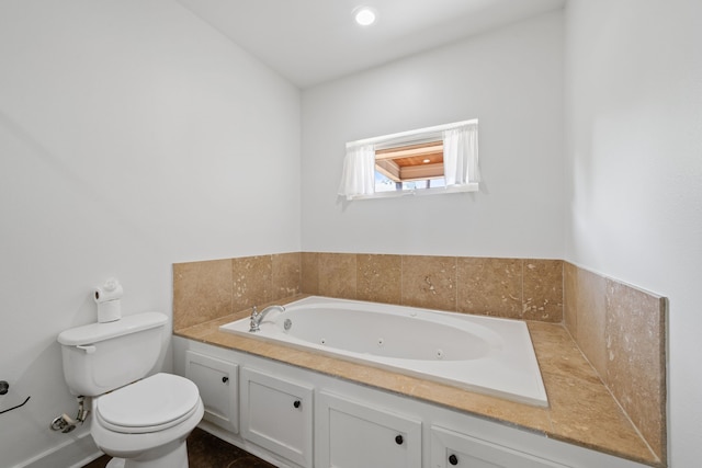 1226 Peden St, Houston, TX 77006 - bathroom featuring a tub with jets and toilet