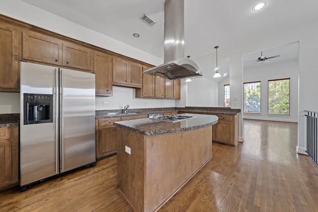 1226 Peden St, Houston, TX 77006 - kitchen featuring stainless steel appliances, island exhaust hood, a kitchen island, dark wood-style flooring, and ceiling fan