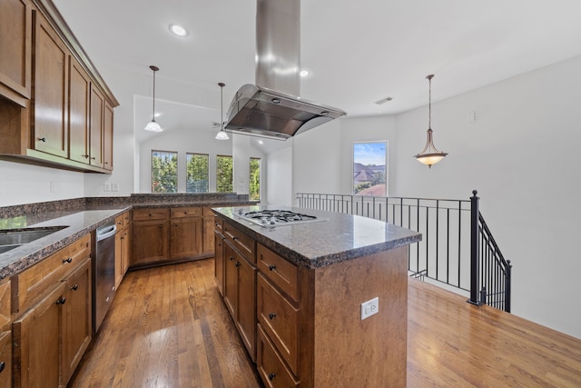 1226 Peden St, Houston, TX 77006 - kitchen featuring island exhaust hood, appliances with stainless steel finishes, light wood-style flooring, pendant lighting, and recessed lighting