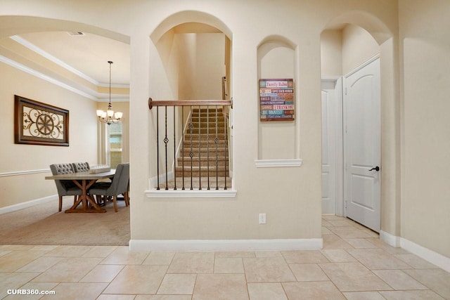 1522 Richland Hollow Ln, Friendswood, TX 77546 - tiled empty room with crown molding, stairs, a chandelier, and baseboards