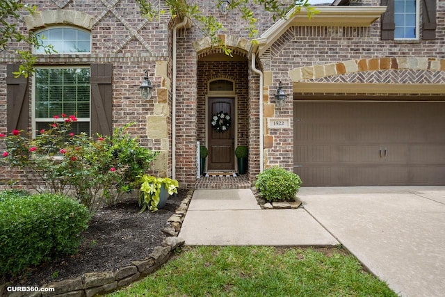 1522 Richland Hollow Ln, Friendswood, TX 77546 - property entrance featuring brick siding, concrete driveway, and a garage