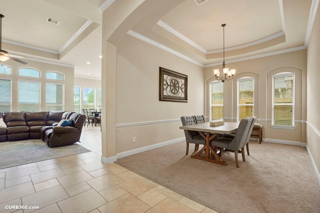 1522 Richland Hollow Ln, Friendswood, TX 77546 - dining room featuring a raised ceiling, crown molding, a ceiling fan, a chandelier, and arched walkways