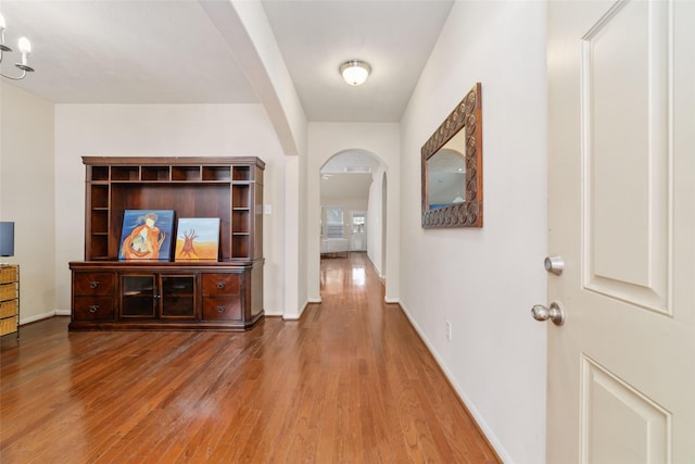 24526 Carlton Springs Ln, Katy, TX 77494 - hall featuring arched walkways, wood finished floors, and baseboards