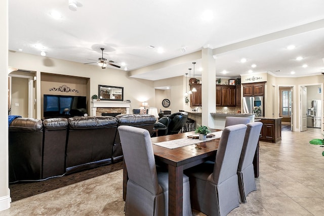5702 Mustang Ridge Ln, Fulshear, TX 77441 - dining area featuring a ceiling fan, crown molding, recessed lighting, and a stone fireplace