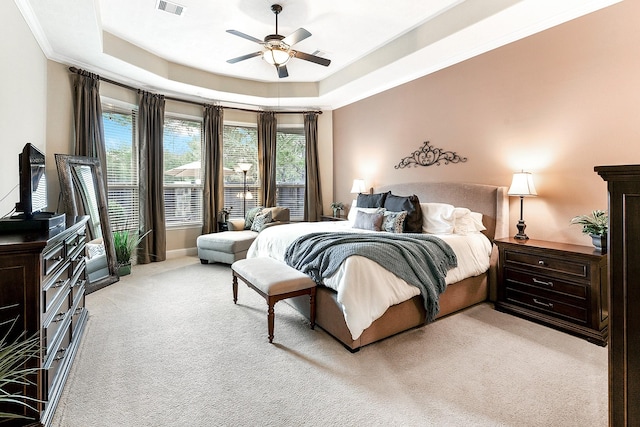 5702 Mustang Ridge Ln, Fulshear, TX 77441 - bedroom with light colored carpet, a tray ceiling, a ceiling fan, and crown molding