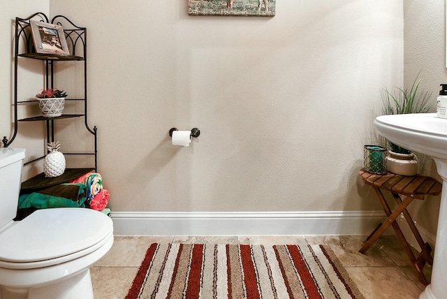 5702 Mustang Ridge Ln, Fulshear, TX 77441 - half bathroom with baseboards, toilet, and tile patterned flooring