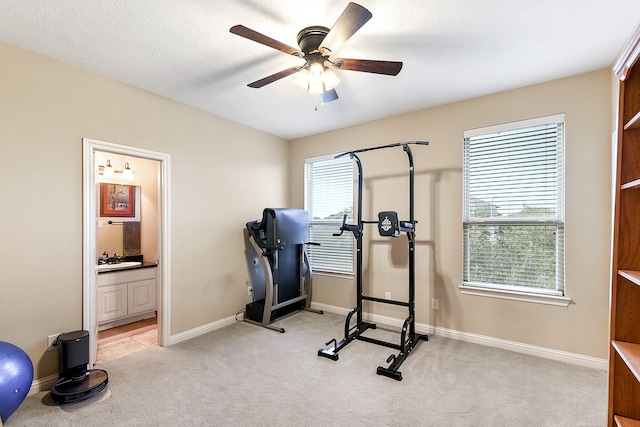 5702 Mustang Ridge Ln, Fulshear, TX 77441 - exercise room featuring ceiling fan, light colored carpet, and baseboards