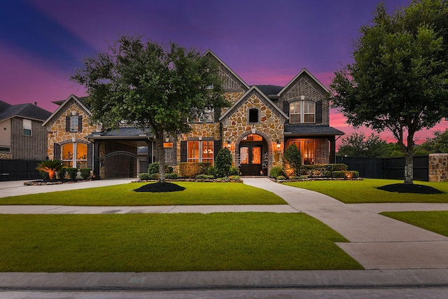 5702 Mustang Ridge Ln, Fulshear, TX 77441 - view of front of house featuring stone siding, french doors, and driveway