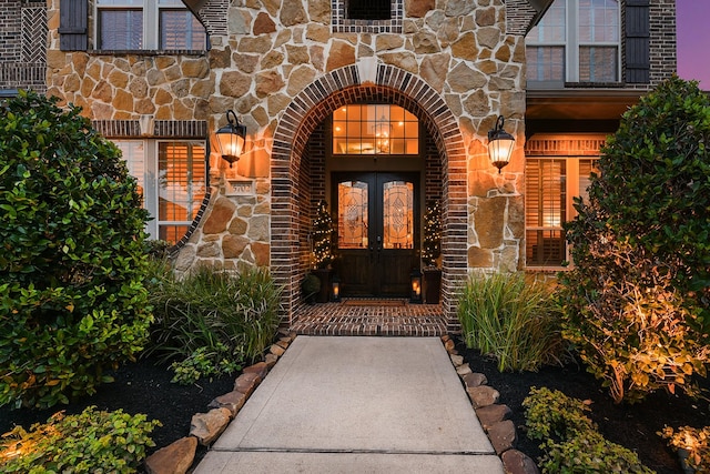 5702 Mustang Ridge Ln, Fulshear, TX 77441 - property entrance with stone siding, french doors, and brick siding