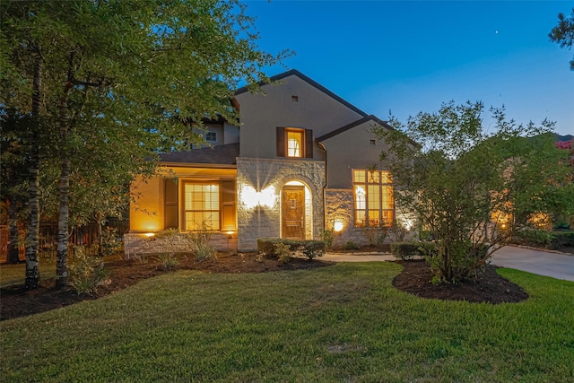 105 Checkerbloom Ct, Montgomery, TX 77316 - view of front facade featuring stone siding, stucco siding, a front lawn, and concrete driveway