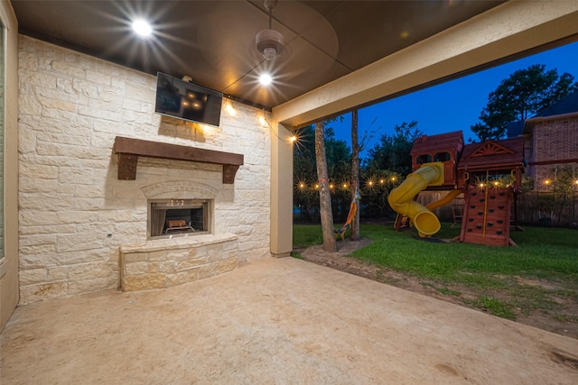 105 Checkerbloom Ct, Montgomery, TX 77316 - view of patio featuring an outdoor stone fireplace and a playground
