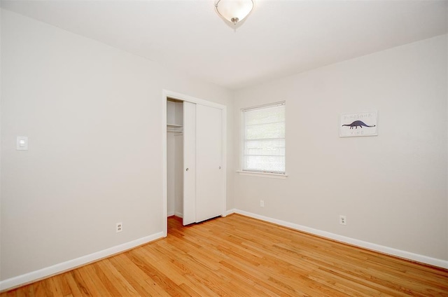 4410 Spellman Rd, Houston, TX 77035 - unfurnished bedroom featuring baseboards, light wood finished floors, and a closet