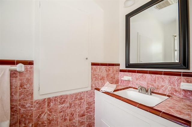 4410 Spellman Rd, Houston, TX 77035 - bathroom featuring vanity, tile walls, and wainscoting
