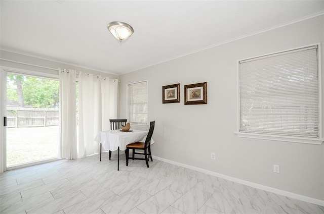 4410 Spellman Rd, Houston, TX 77035 - dining room featuring plenty of natural light, crown molding, baseboards, and light marble finish flooring