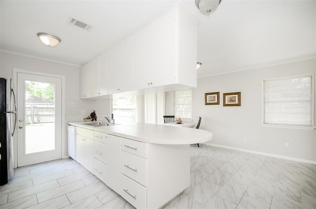 4410 Spellman Rd, Houston, TX 77035 - kitchen featuring a peninsula, light marble finish flooring, light countertops, ornamental molding, and white cabinetry