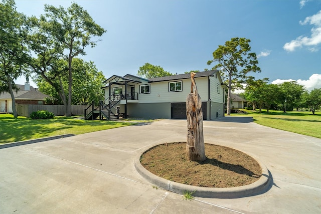 719 Fairfield St, Shoreacres, TX 77571 - view of front of property with curved driveway, a garage, and stairs