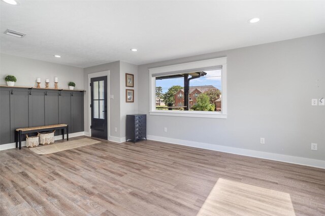 719 Fairfield St, Shoreacres, TX 77571 - unfurnished living room featuring light wood finished floors, baseboards, and recessed lighting