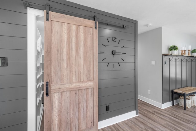 719 Fairfield St, Shoreacres, TX 77571 - detailed view of wood finished floors, baseboards, a smoke detector, and a barn door