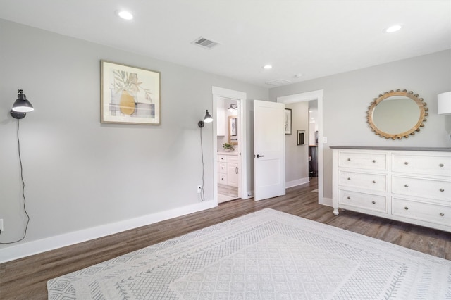 719 Fairfield St, Shoreacres, TX 77571 - bedroom with dark wood finished floors, baseboards, recessed lighting, and connected bathroom