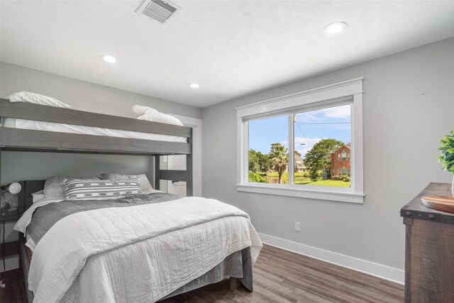 719 Fairfield St, Shoreacres, TX 77571 - bedroom with baseboards, wood finished floors, and recessed lighting