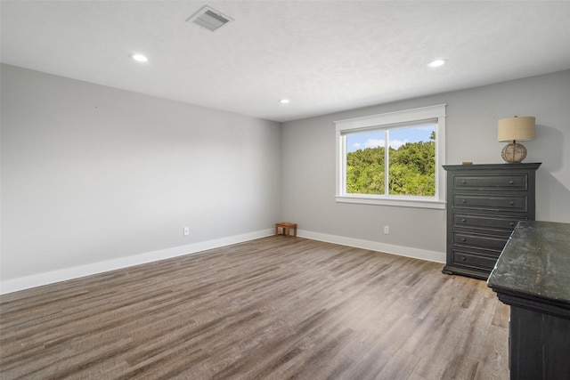 719 Fairfield St, Shoreacres, TX 77571 - unfurnished bedroom featuring light wood finished floors, baseboards, and recessed lighting