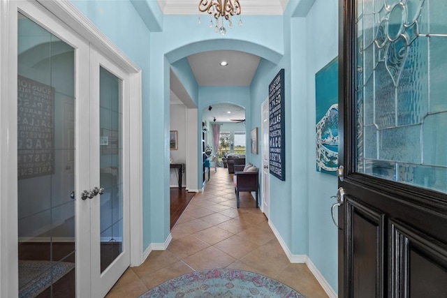 4510 Bonita Way, League City, TX 77573 - entrance foyer featuring arched walkways, light tile patterned floors, baseboards, french doors, and a chandelier