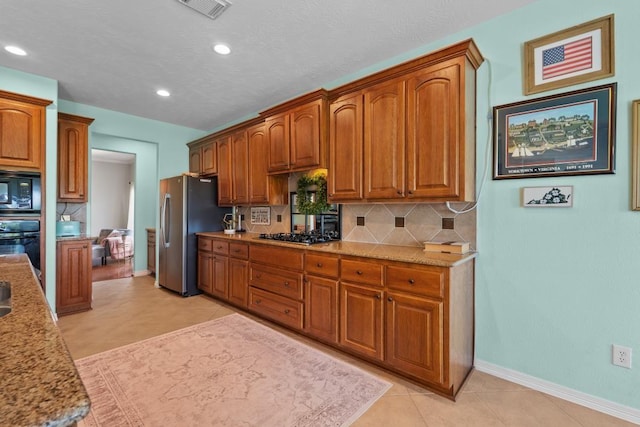 4510 Bonita Way, League City, TX 77573 - kitchen featuring black appliances, backsplash, recessed lighting, brown cabinets, and baseboards