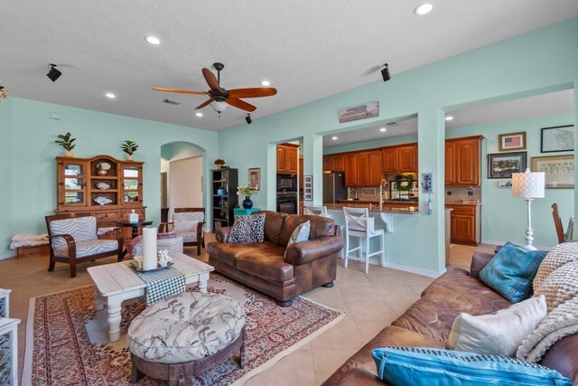 4510 Bonita Way, League City, TX 77573 - living room featuring recessed lighting, a ceiling fan, arched walkways, and light tile patterned floors