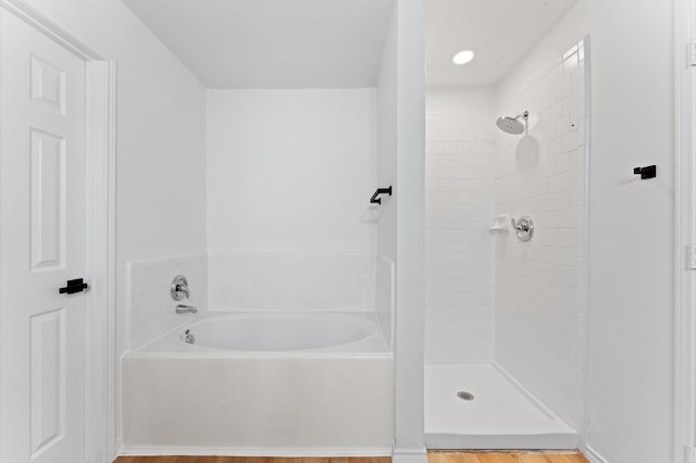 2411 Irish Spring Dr, Houston, TX 77067 - bathroom featuring a bath, a tile shower, and wood finished floors