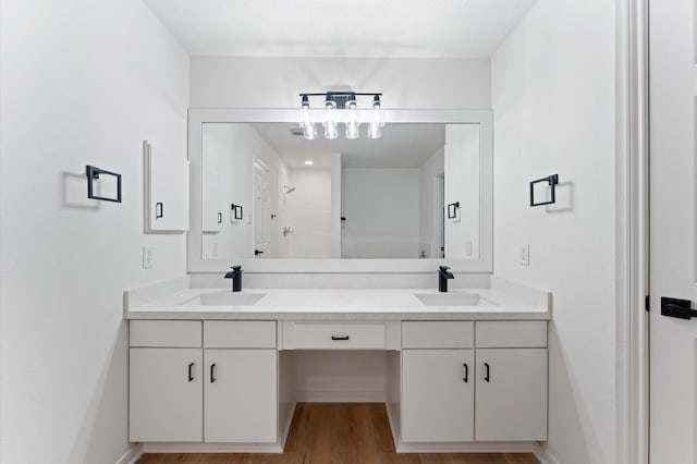 2411 Irish Spring Dr, Houston, TX 77067 - bathroom with double vanity, wood finished floors, and tiled shower