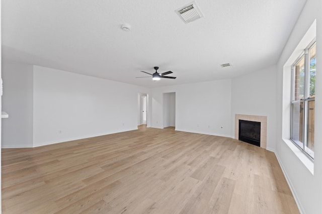 2411 Irish Spring Dr, Houston, TX 77067 - unfurnished living room with light wood-style floors, a fireplace, ceiling fan, and baseboards