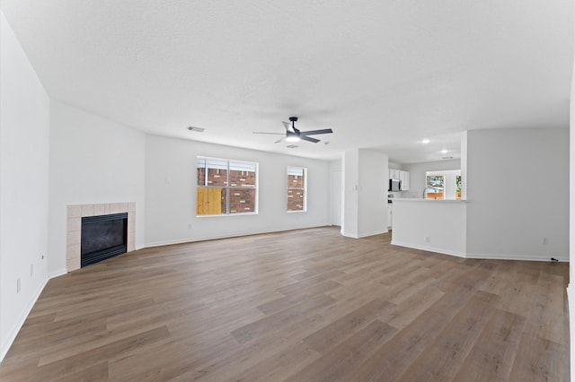 2411 Irish Spring Dr, Houston, TX 77067 - unfurnished living room with ceiling fan, healthy amount of natural light, light wood-type flooring, and recessed lighting