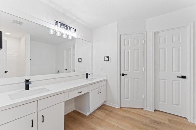 2411 Irish Spring Dr, Houston, TX 77067 - bathroom with double vanity and wood finished floors