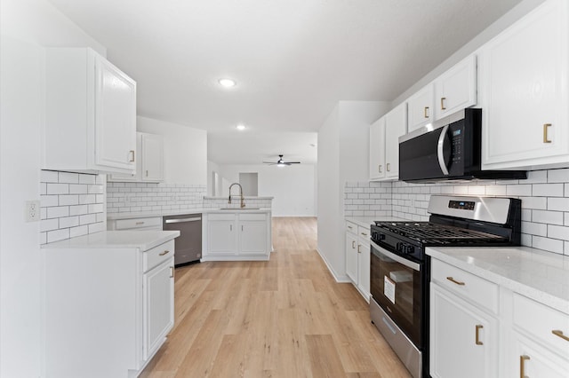 2411 Irish Spring Dr, Houston, TX 77067 - kitchen featuring stainless steel appliances, a peninsula, a sink, tasteful backsplash, and recessed lighting