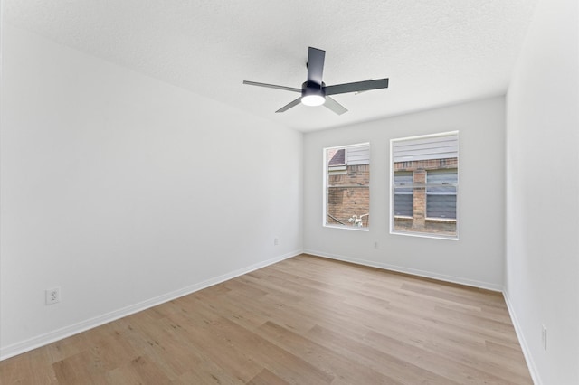 2411 Irish Spring Dr, Houston, TX 77067 - spare room with light wood-type flooring, a ceiling fan, baseboards, and a textured ceiling