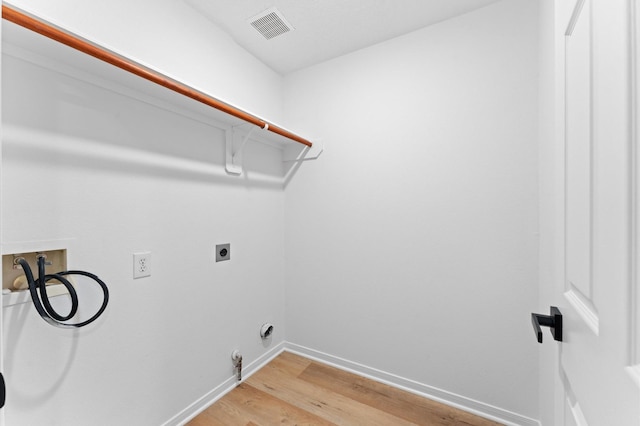 2411 Irish Spring Dr, Houston, TX 77067 - washroom featuring washer hookup, electric dryer hookup, light wood finished floors, baseboards, and gas dryer hookup