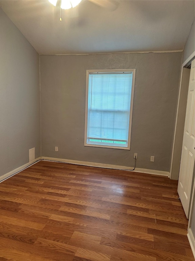 227 S Brownell St, La Porte, TX 77571 - unfurnished bedroom with wood finished floors, baseboards, and ceiling fan