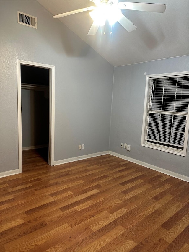 227 S Brownell St, La Porte, TX 77571 - unfurnished bedroom featuring vaulted ceiling, wood finished floors, a walk in closet, ceiling fan, and baseboards