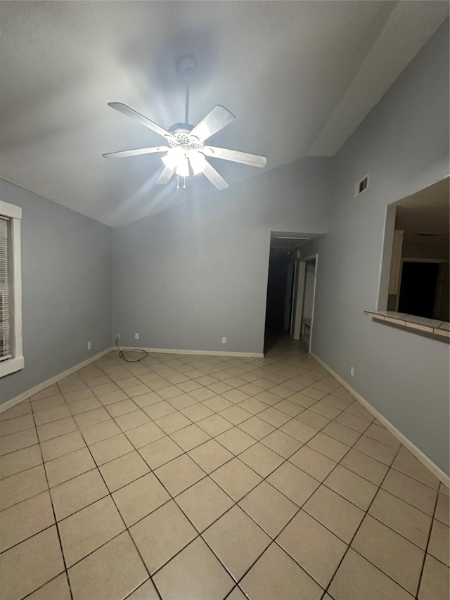227 S Brownell St, La Porte, TX 77571 - spare room with vaulted ceiling, ceiling fan, light tile patterned floors, and baseboards